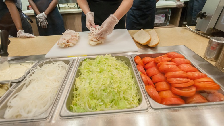 A Jersey Mike's worker making a sandwich.
