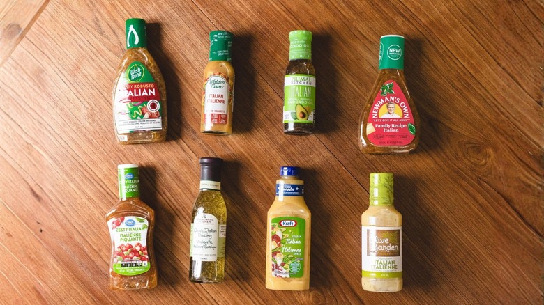 8 salad dressings on brown wooden background