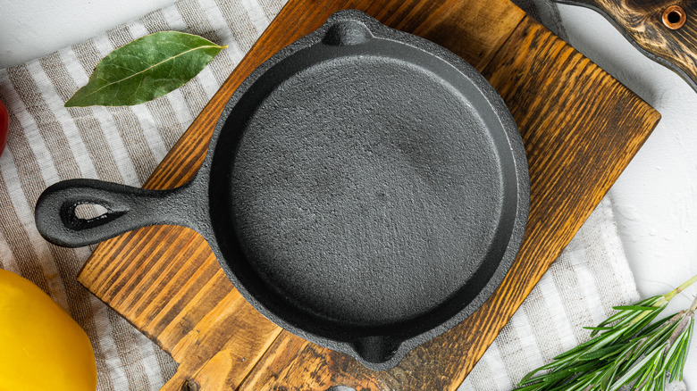 cast iron skillet on wooden cutting board