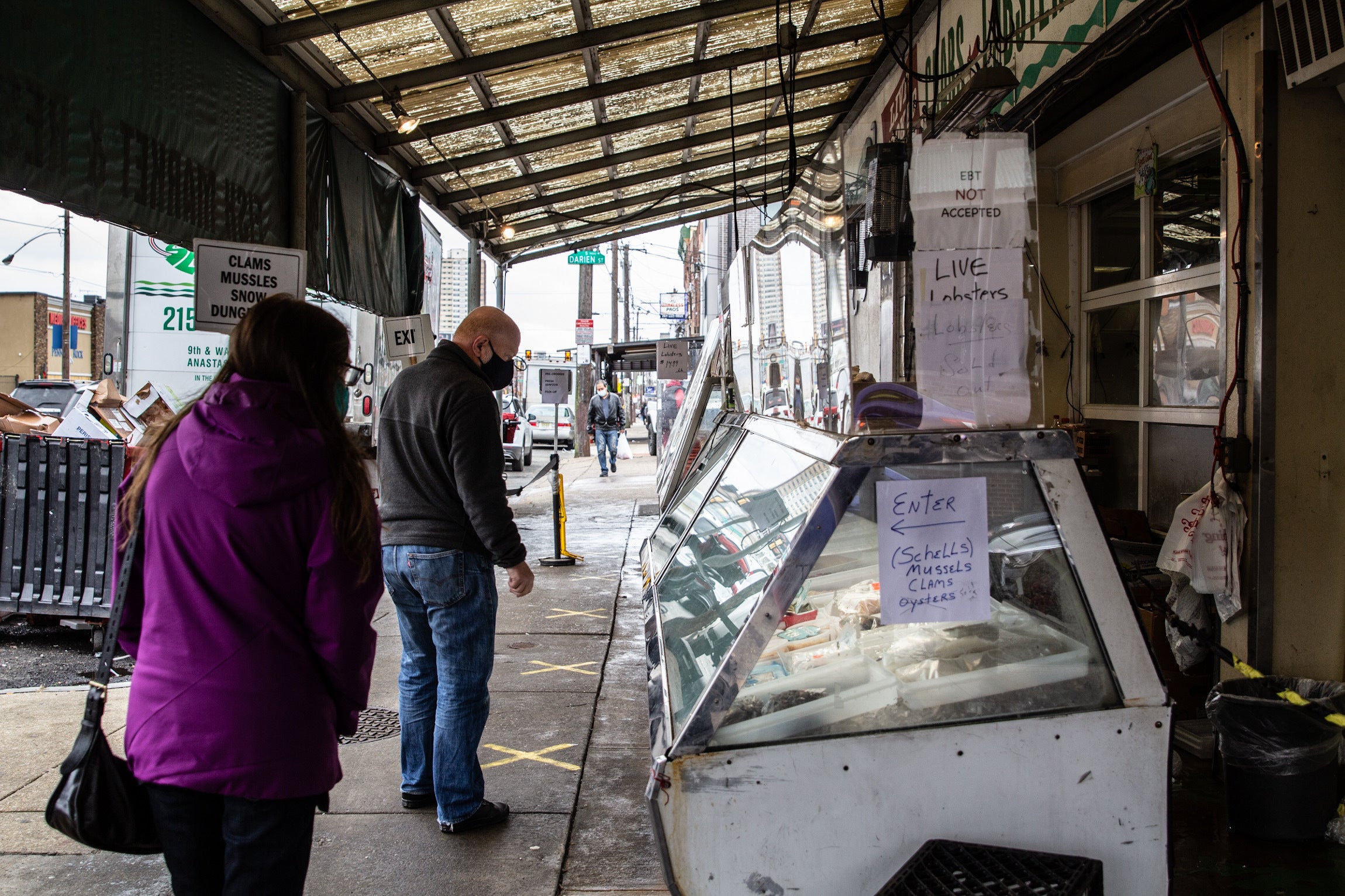 Customers wait in line at Anastasi’s Seafood in the Italian Market.