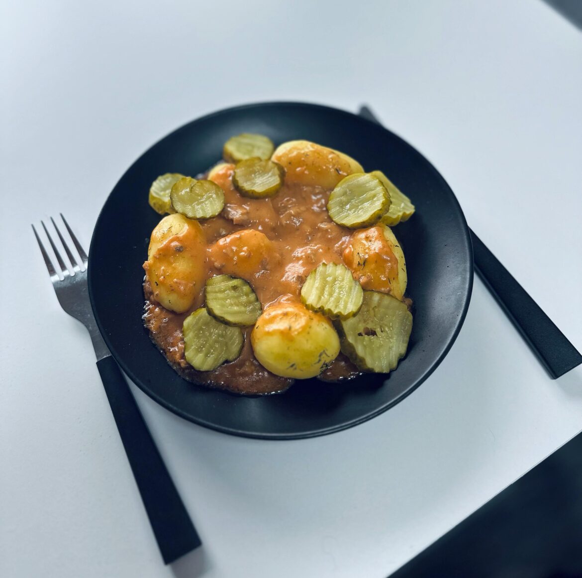 Turkey goulash with boiles potatoes and pickles