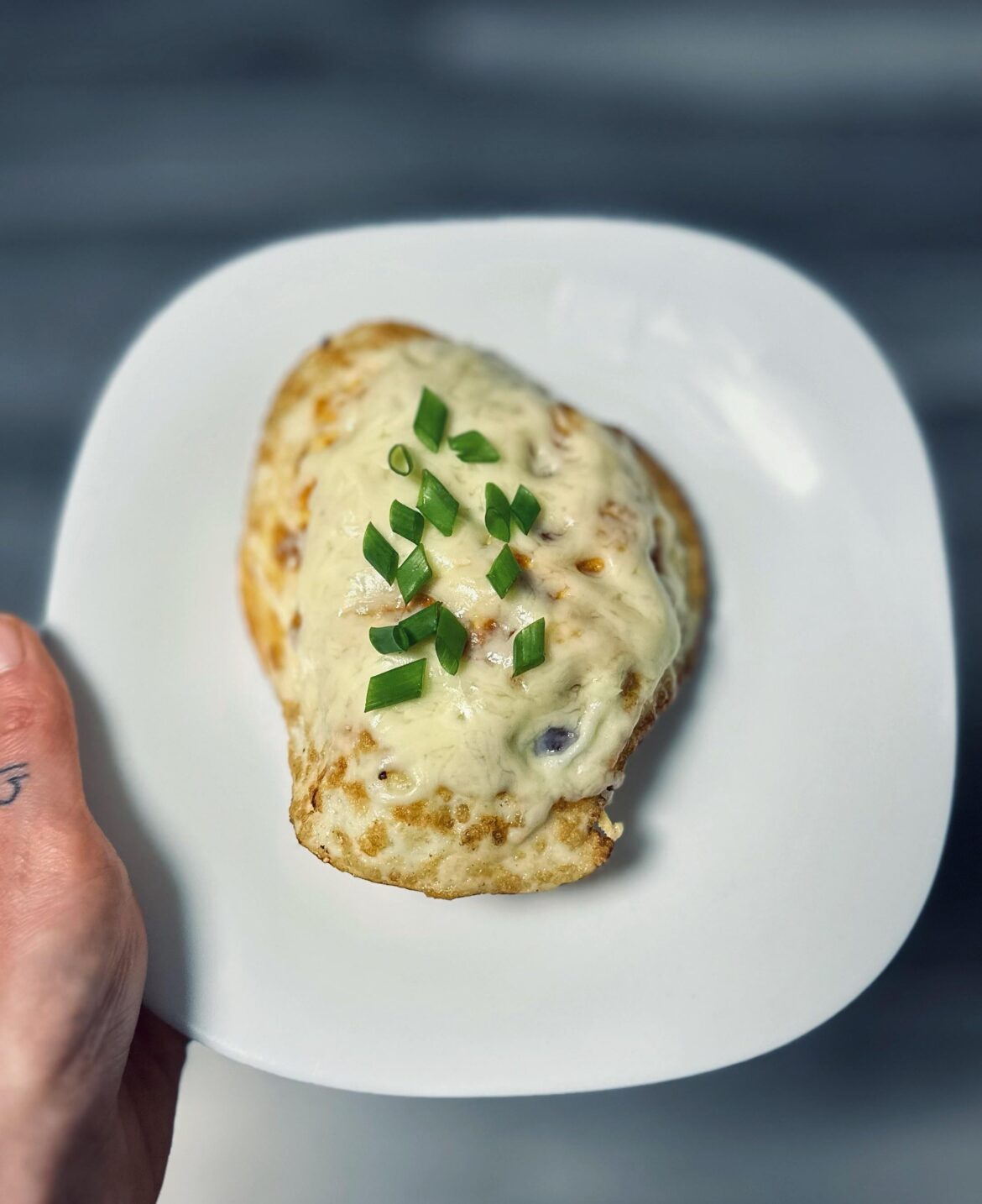 There is beauty in simplicity: Fried egg, cheese, and green onion on ciabatta.