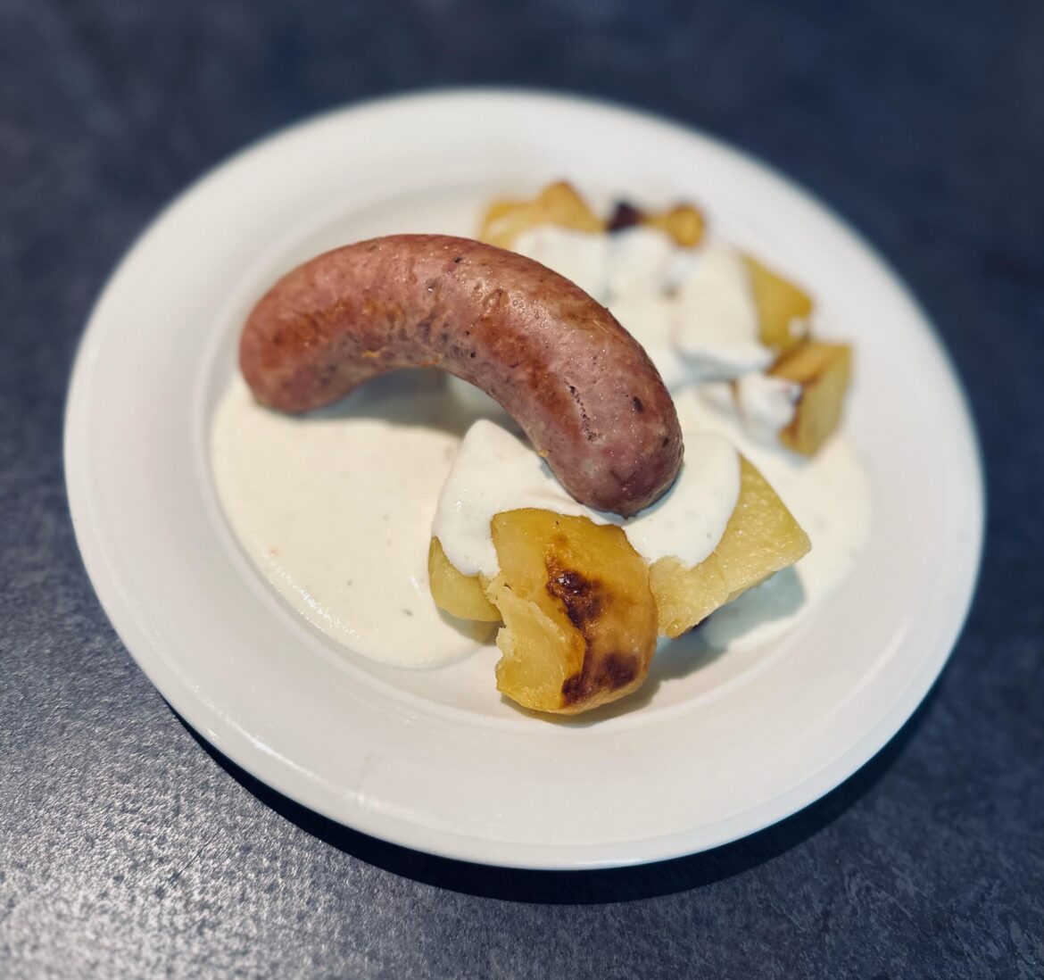 Sausage, oven potatoes and warm sauce