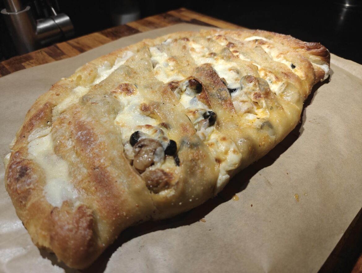 Alcohol may have influenced the amount of cheese on this calzone...