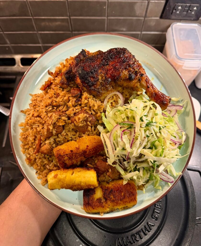 Arroz con pork belly, roasted chicken, fried plantains and cabbage.