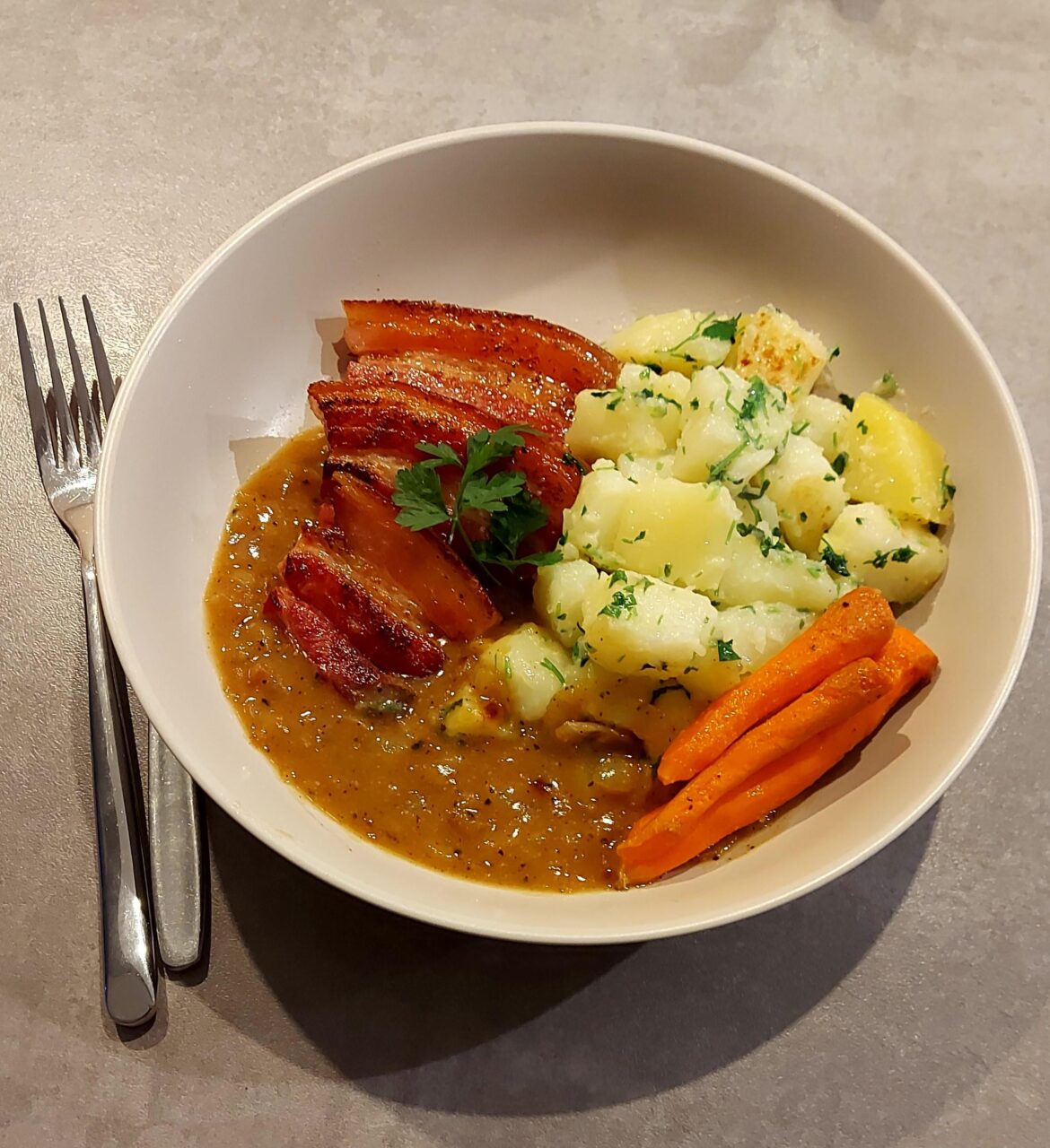 Kolozsvári szalonna (Hungarian bacon) with buttered parsley potatoes and onion gravy