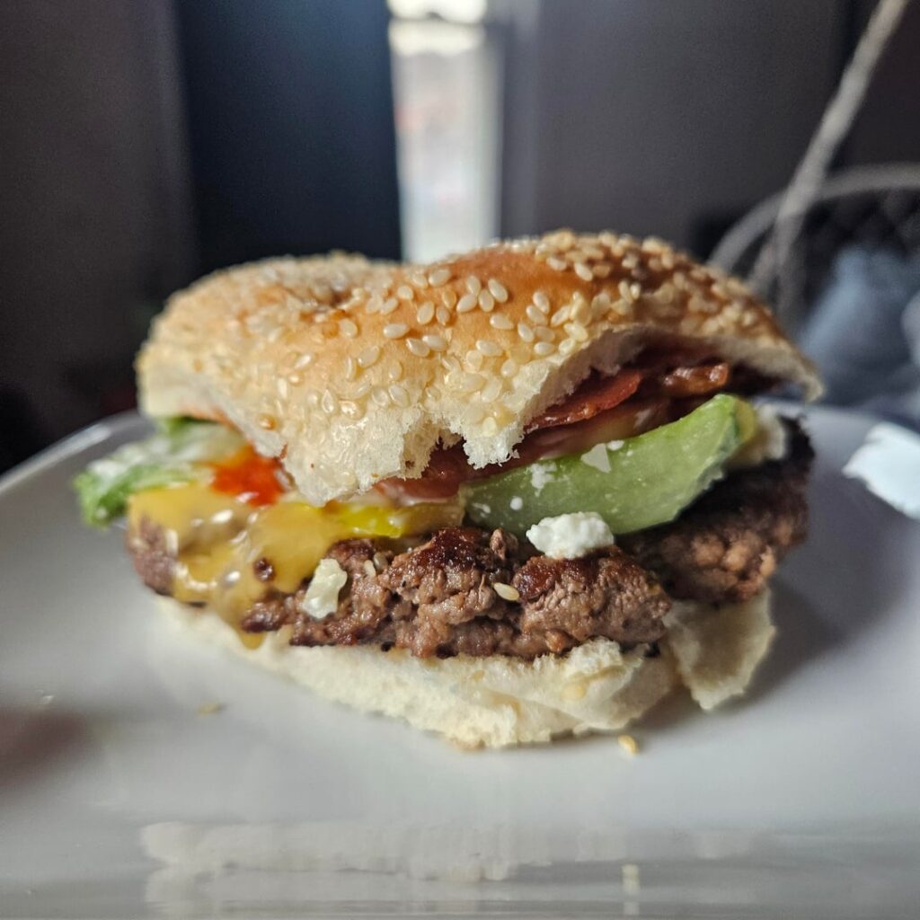 My weekly treat. I jazzed it up alittle with some feta and asiago crumbles. Yellow american, lettuce tomatoes and 5 crispy bacon strips. Lots of ketchup and mayo 😋