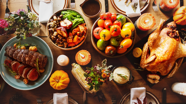 A wooden table set with many holiday food items