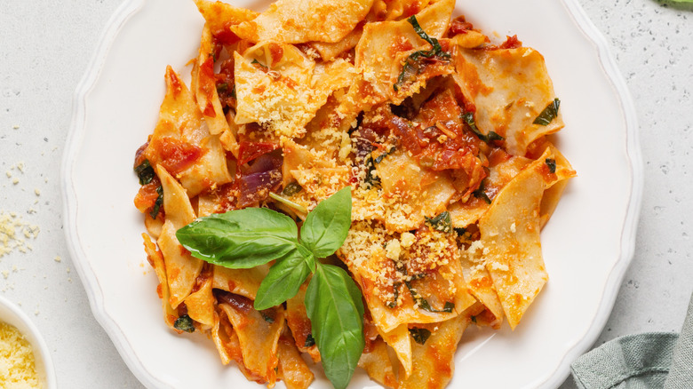Maltagliati tossed with cheese and tomatoes and basil