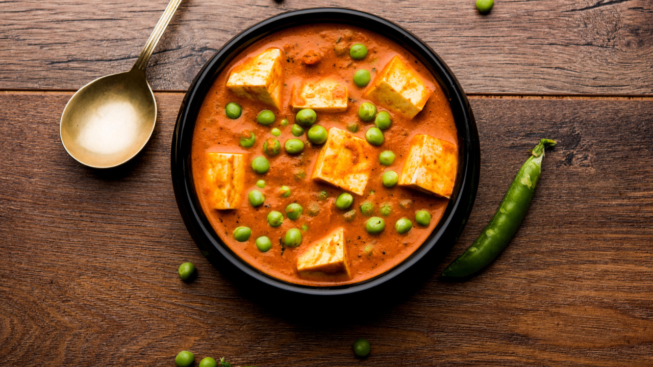 With matar paneer, comfort comes easy. Start by letting green peas simmer in a spiced tomato base until they turn tender, their sweetness softening the sharp edges of the masala. Add the paneer cubes and let them settle into the gravy, soaking up the flavours while giving the curry its weight. Once everything comes together - scatter fresh coriander on top. It keeps the dish bright, a small reminder that even the simplest food can feel complete. Matar Paneer