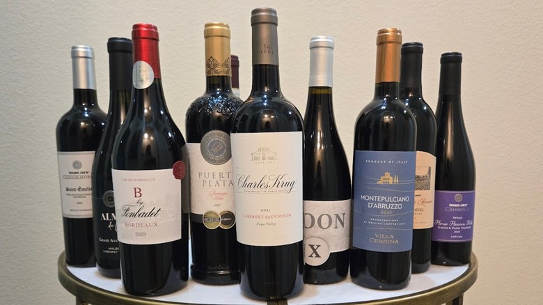 Bottles of Trader Joe's red wines on a table with a white background
