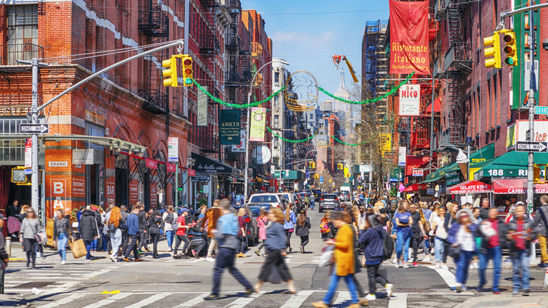 Crowds of people walking through Little Italy in Manhattan