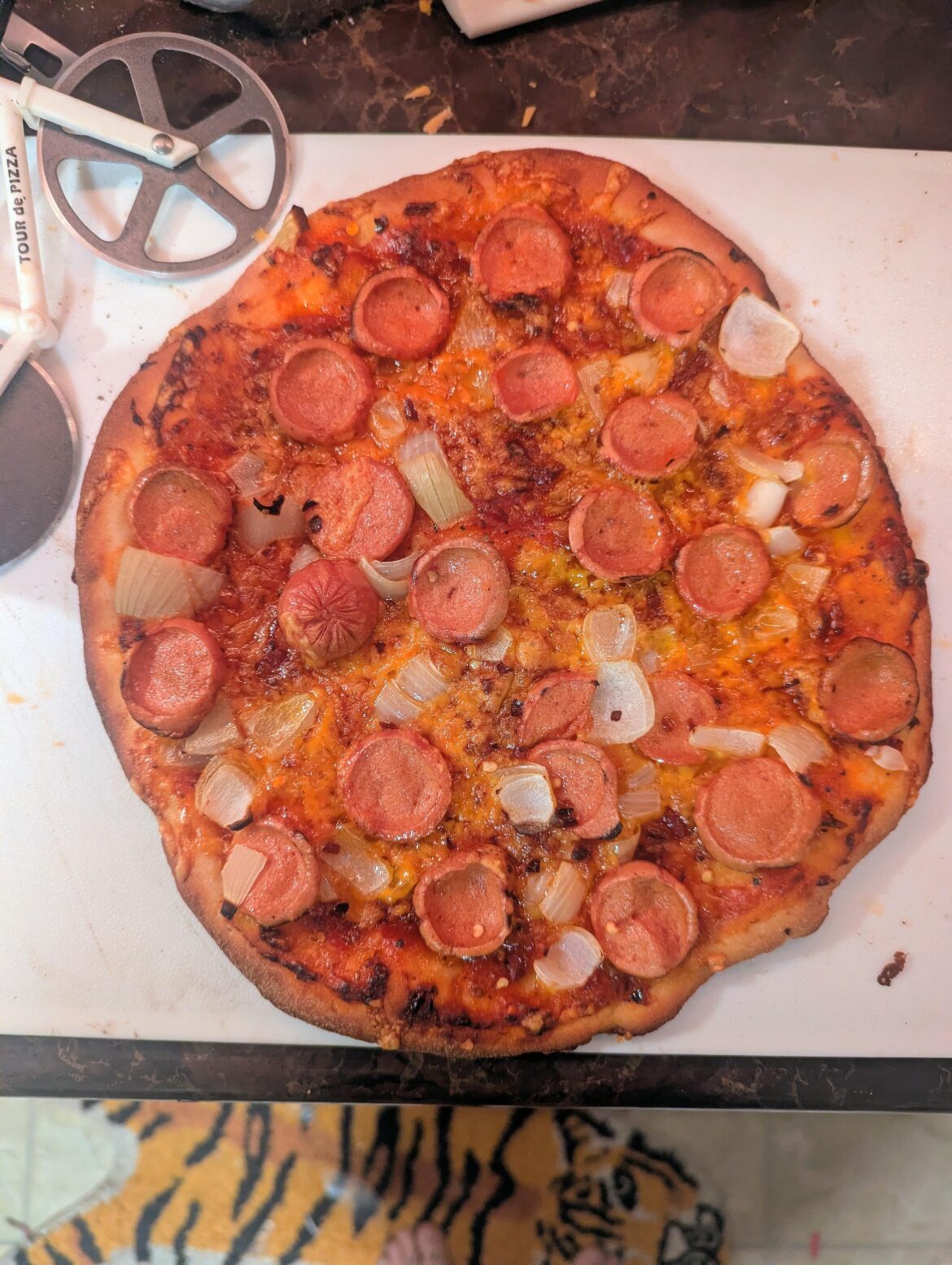 Poverty Pie. Reduced and seasoned Campbell's tomato soup for sauce, chicken hot dog for pep, onion, the less moldy side of some old cheddar and home made dough!