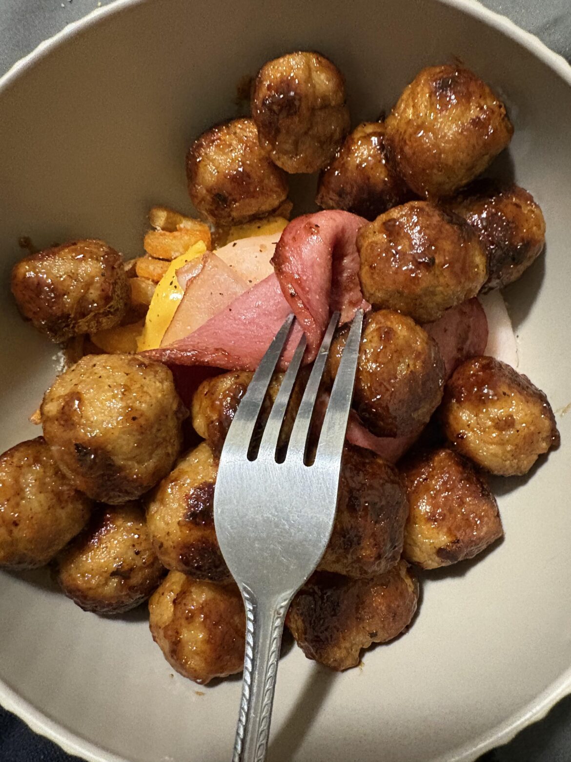 I call it “maple syrup and Texas Pete meatballs over frozen Arby’s fries topped with American cheese, turkey, and bologna”