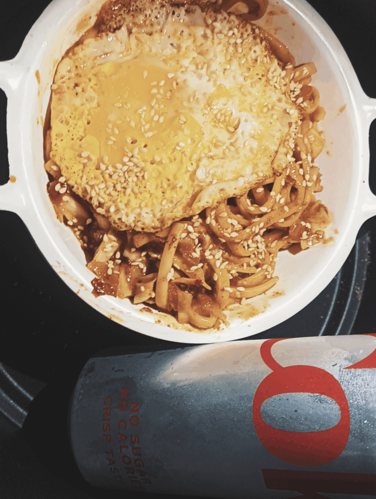 garlic sesame udon noodles with an egg on it