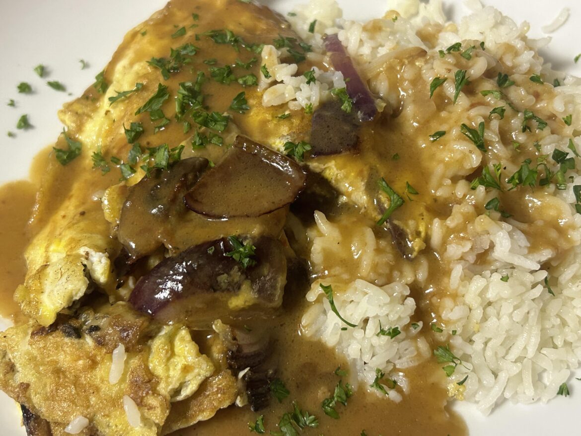 Omelette and rice topped with gravy