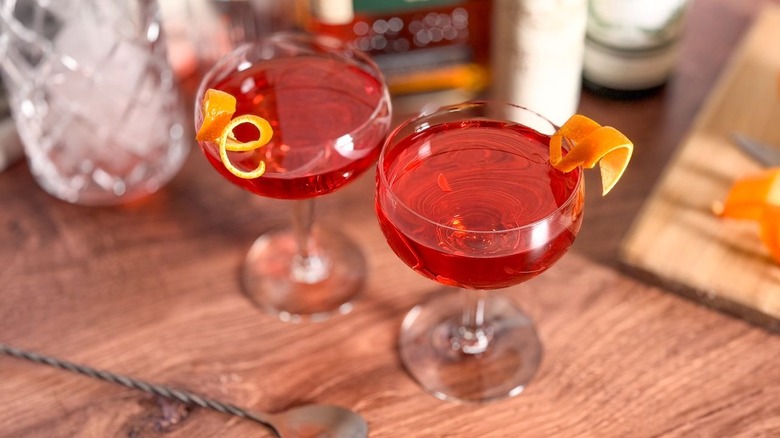 Old Pal cocktails on countertop with stirring spoon and orange twist garnish