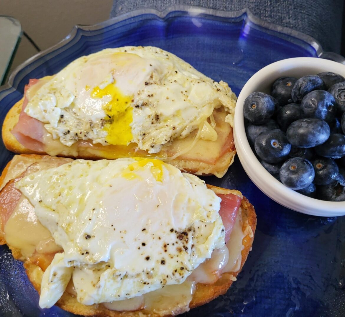 Croque Madame on sourdough with a side of blueberries Croque Madame on sourdough with a side of blueberries
