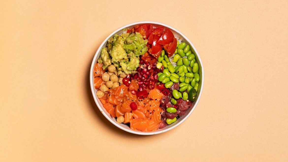 Poke bowl with edamame beans, tomatoes, chickpeas, avocado, tomato and salmon