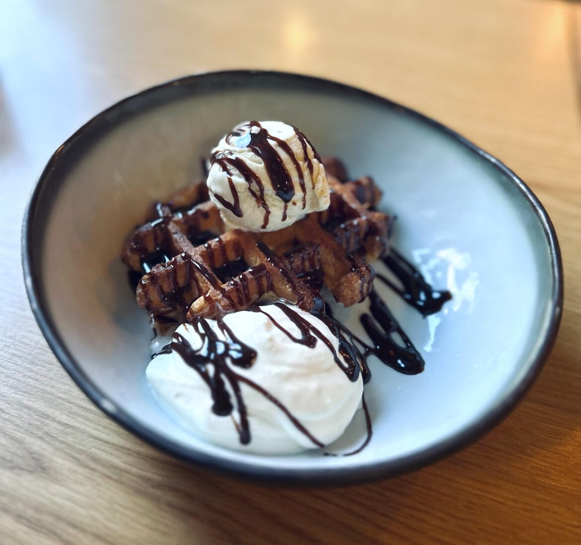 Warm Belgian waffle with ice cream and whipped cream