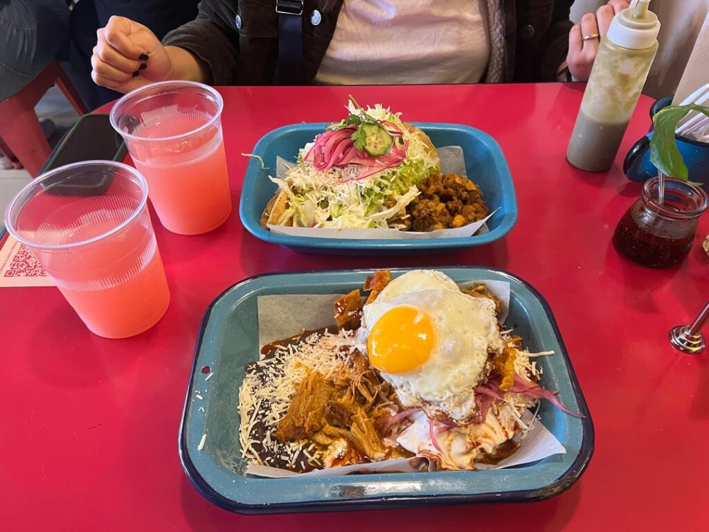 Chilaquiles rojos w/ egg and cochinita pibil and Tacos dorados de papa w/ picadillo + Aguas de sandía