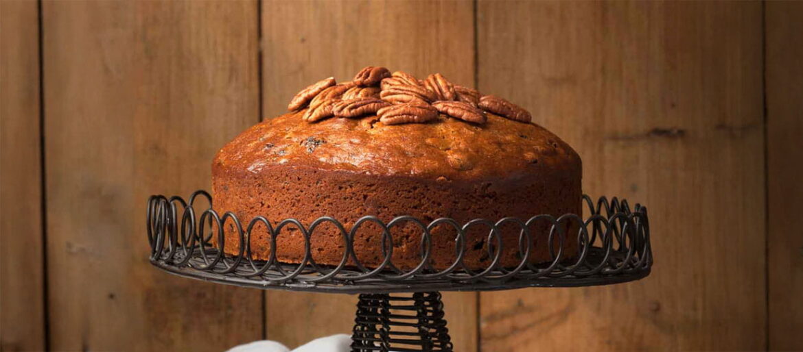 A fruity Christmas cake displayed on a wire cake stand
