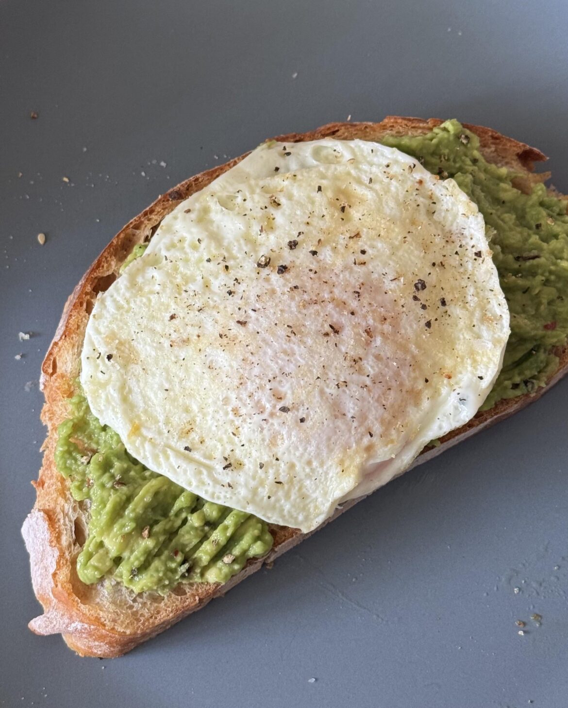avocado toast on homemade bread and an over easy egg