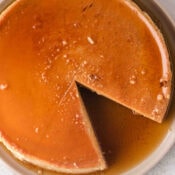a large pumpkin flan with one slice removed