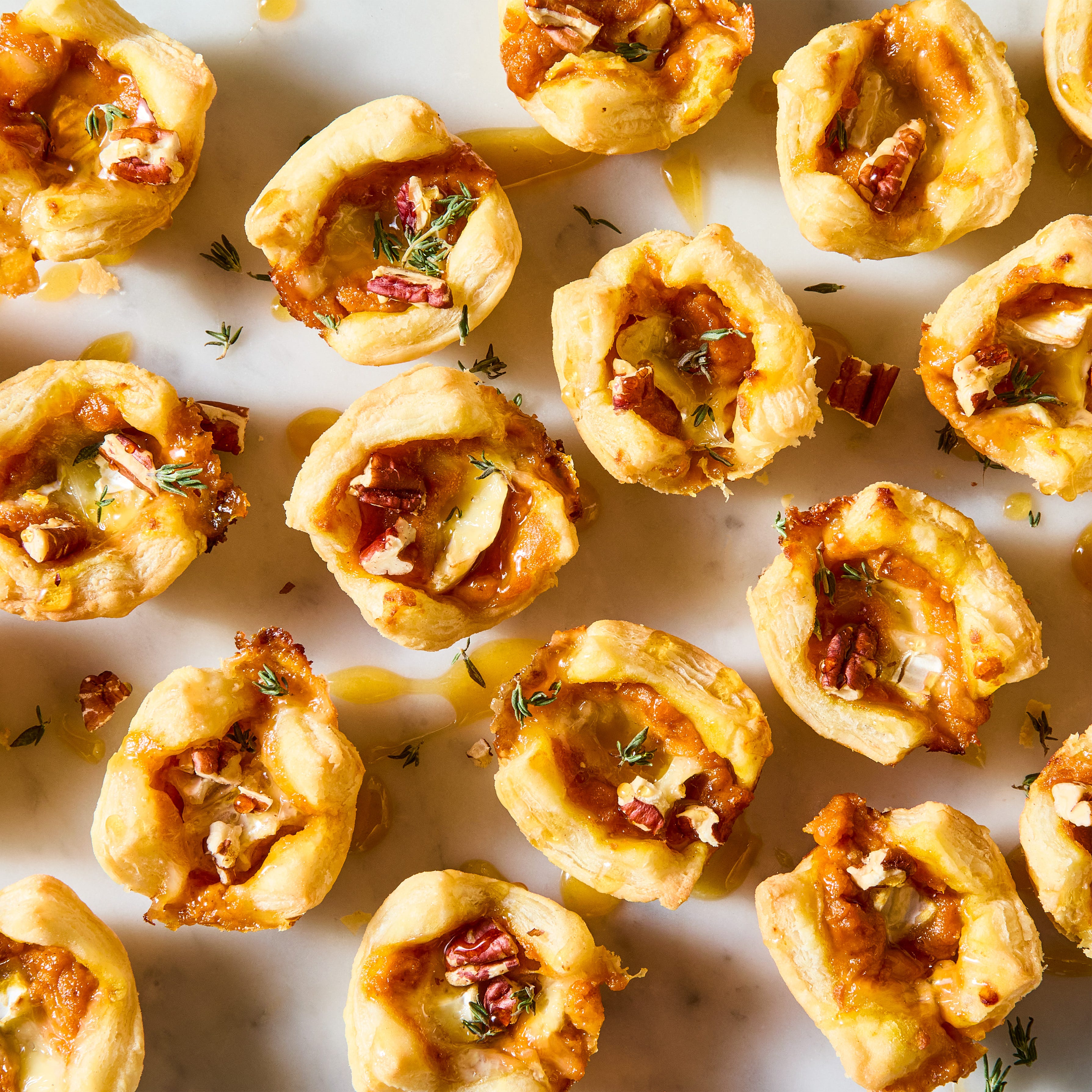 puff pastry bites filled with brie, pumpkin puree, pecans and drizzled with hot honey