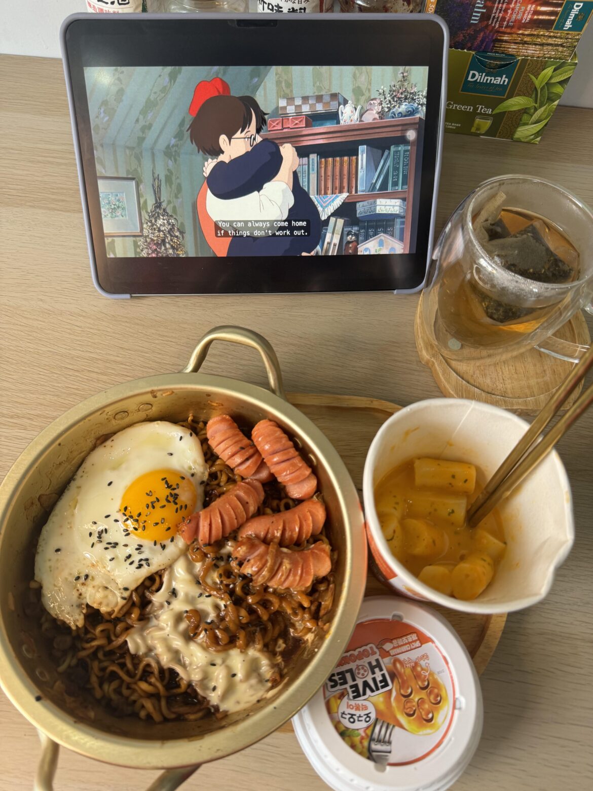 I made Chapagetti with sausage , fried egg and cheese on top and tteokbokki .