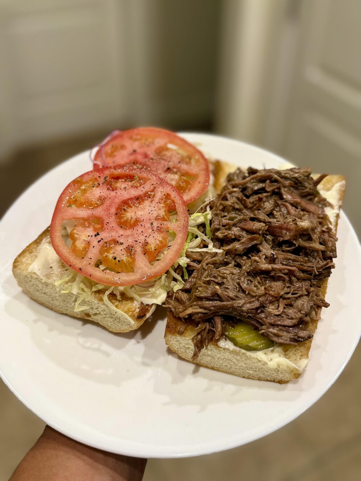 Debris Po Boy roast beef trimmings with au jus, Blue Plate mayo, lettuce, tomato and pickles.