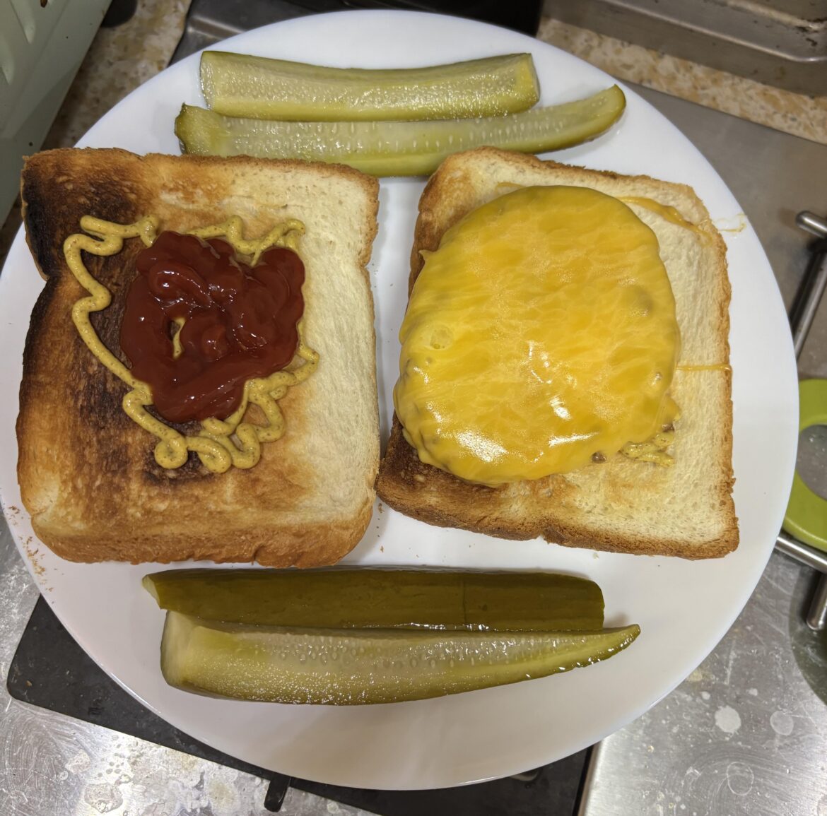 Homemade cheeseburger and homemade pickles for lunch.