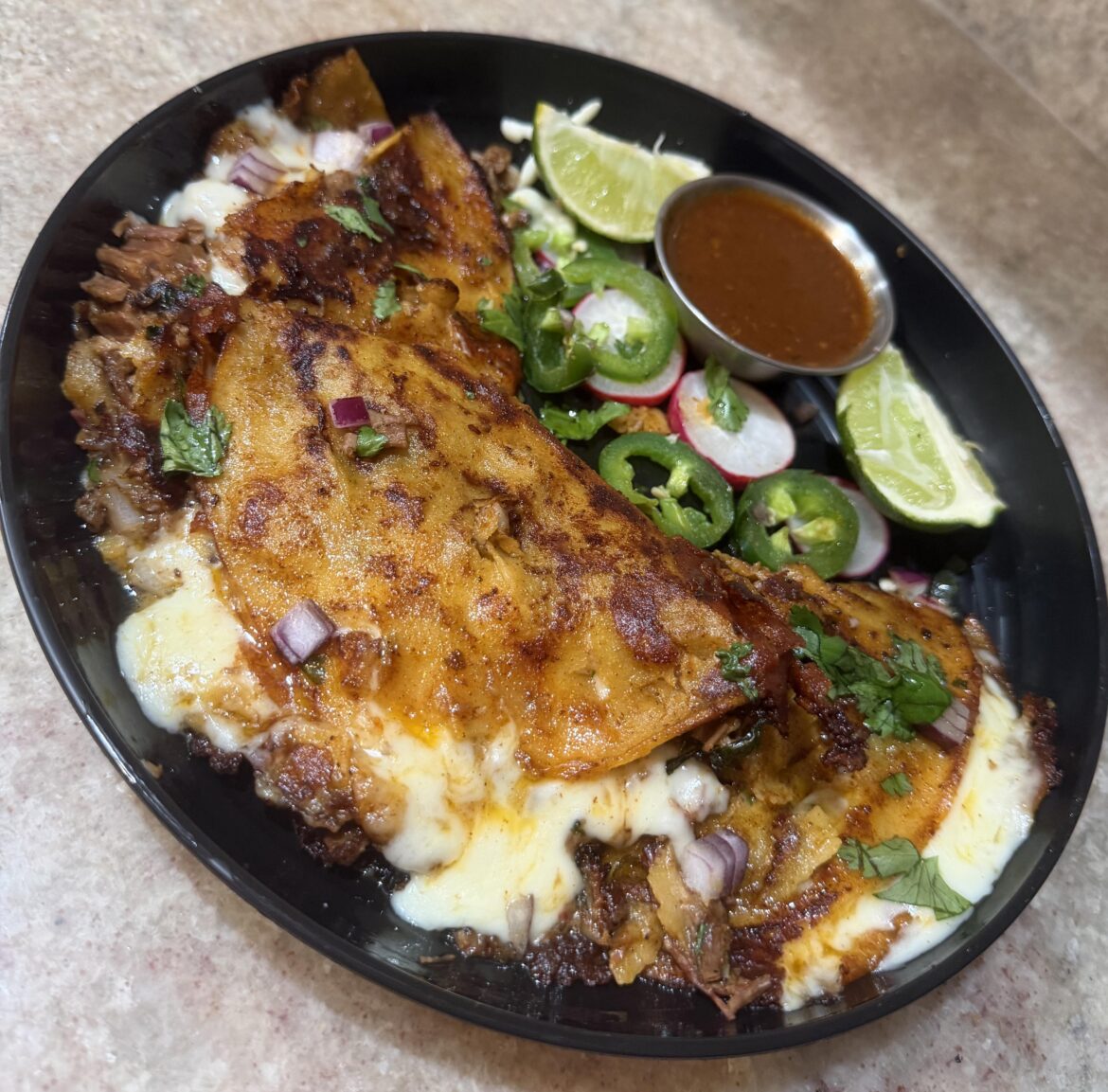 They’re supposed to birria tacos but they look more like quesadillas. What would you say they are?