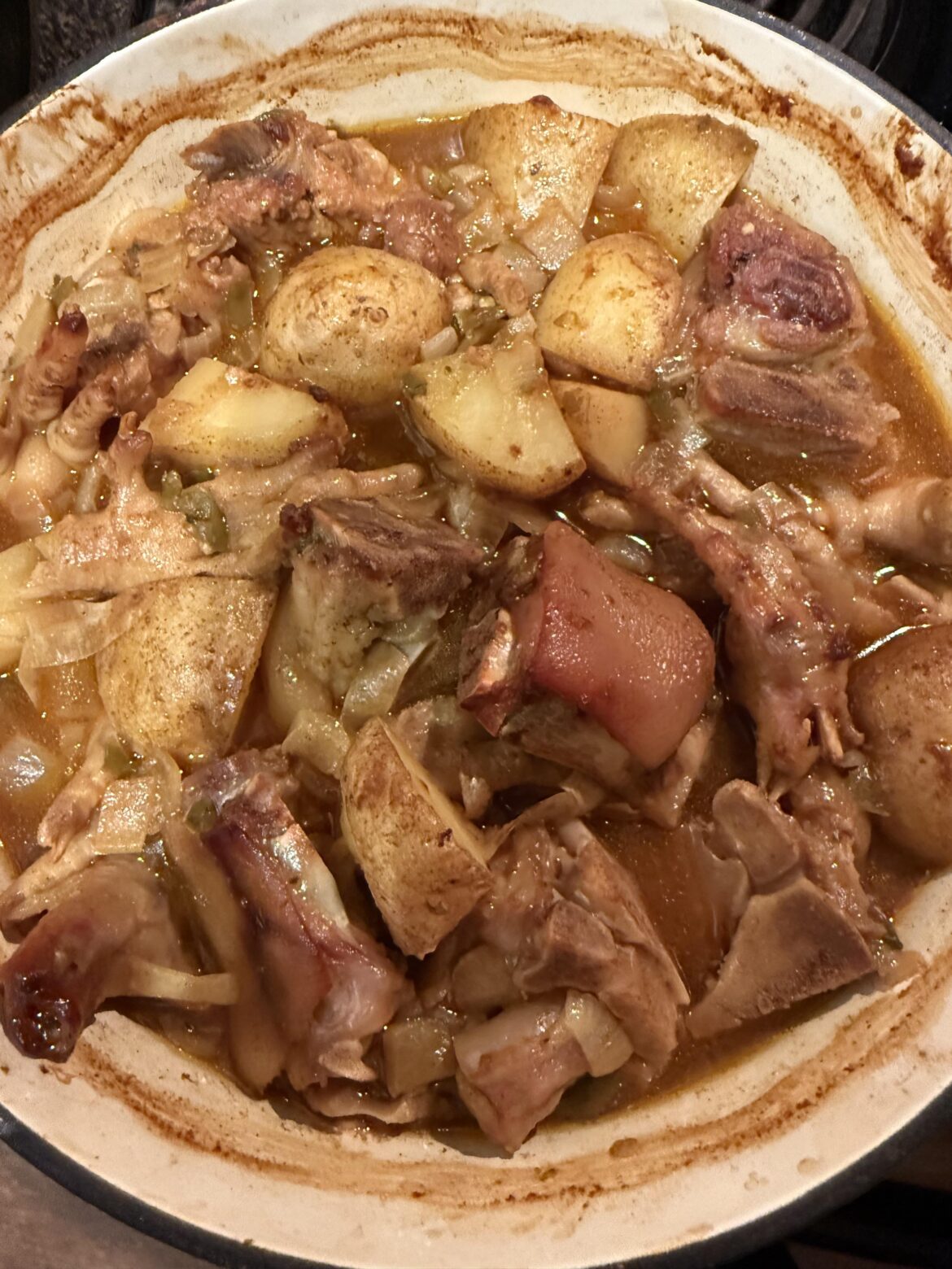 Curried pigs feet, chicken feet, Oxtails, potato stew