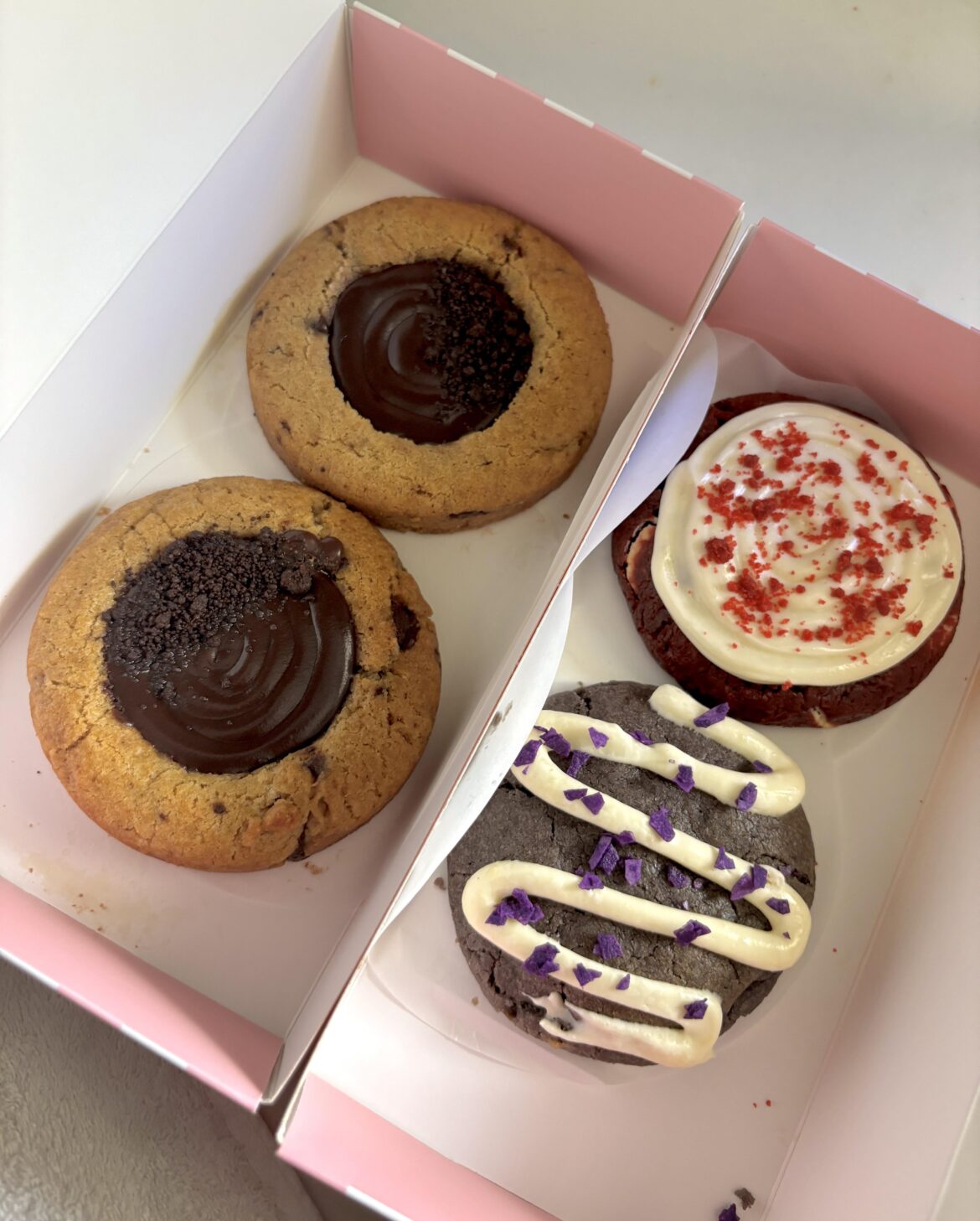 [OC] Today’s cookie spread — chocolate ganache, red velvet cream cheese, and ube cream cheese