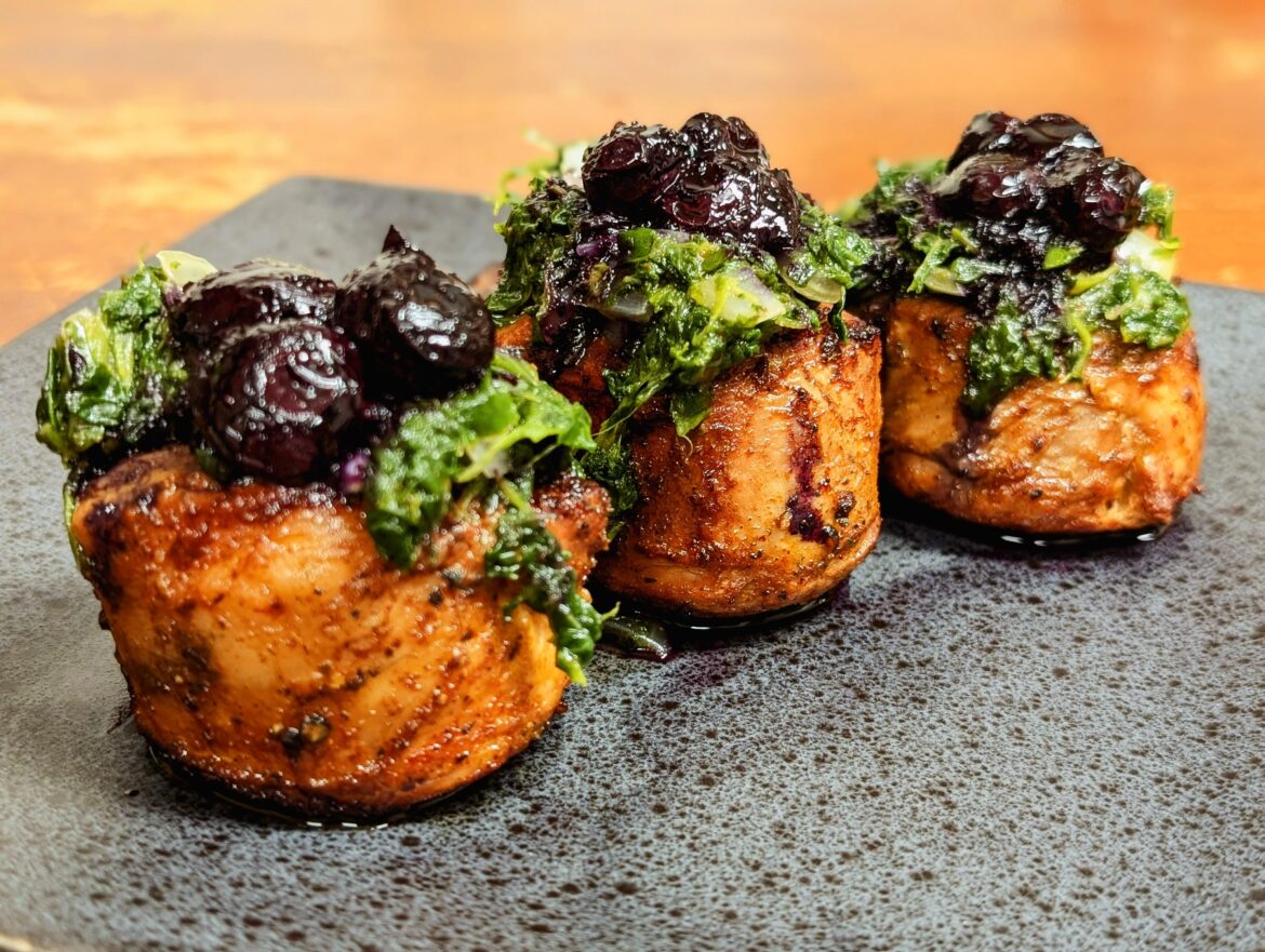 Teriyaki marinated pork medallions topped with sauteed spinach and sweet onion, and a reduced balsamic, cayenne, and blueberry sauce.