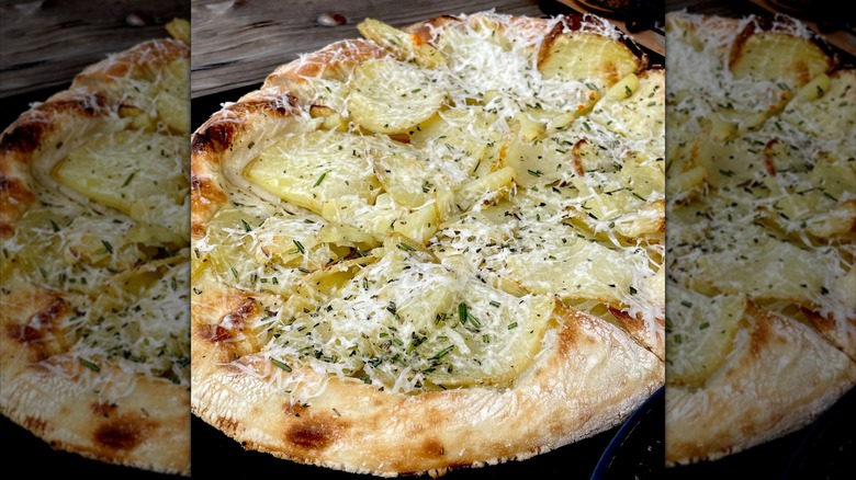 Potato pizza on wooden table