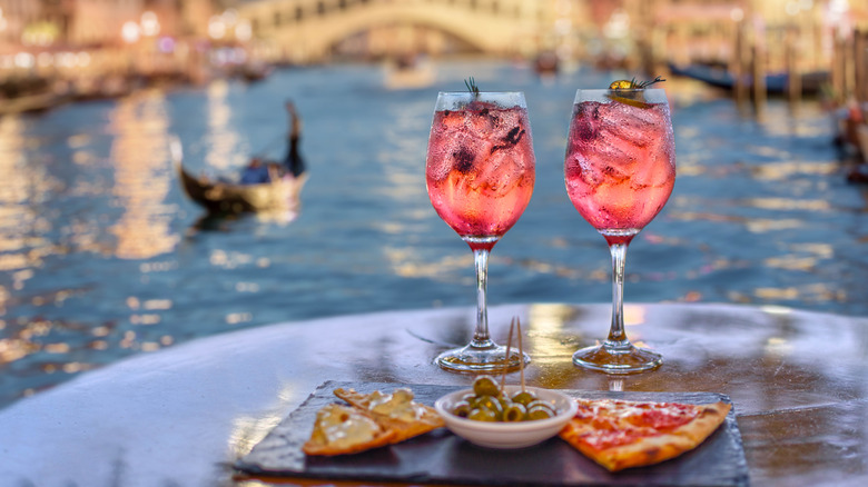 pink drinks and appetizers with the Grand Canal in Venice in the background