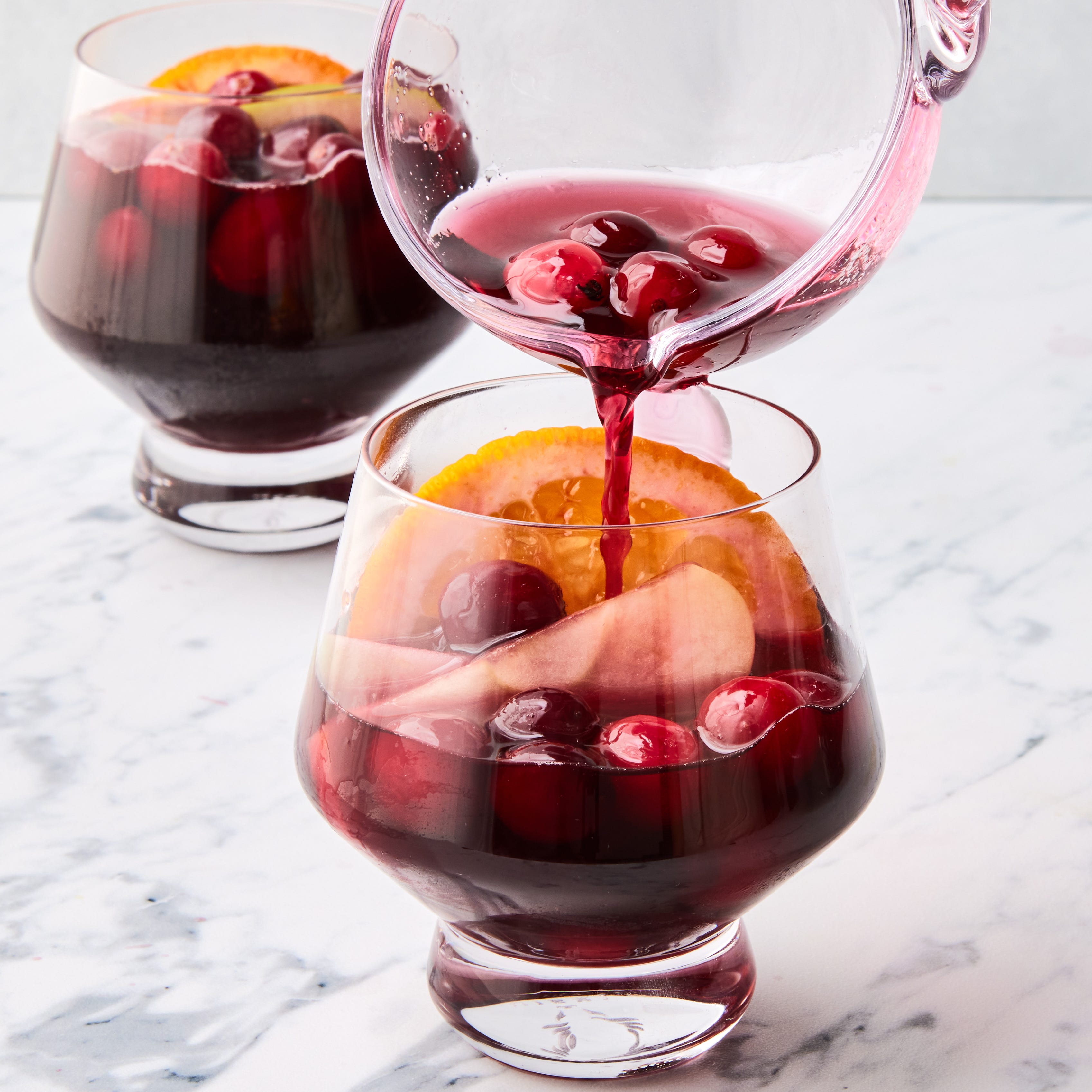 jungle juice with cranberries, apples, and oranges