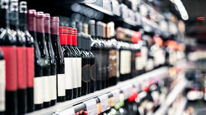 Bottles of red wine on a store shelf