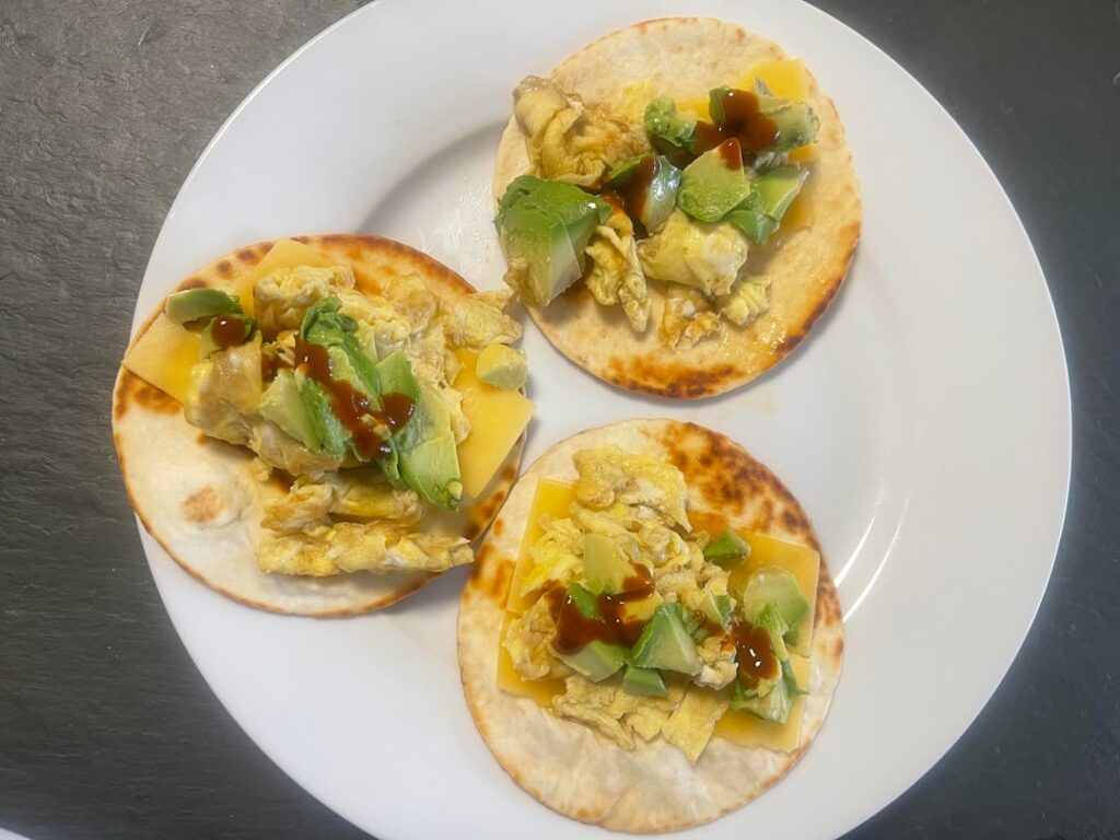 Breakfast tacos have eggs, Gouda cheese, avocado & Cholula
