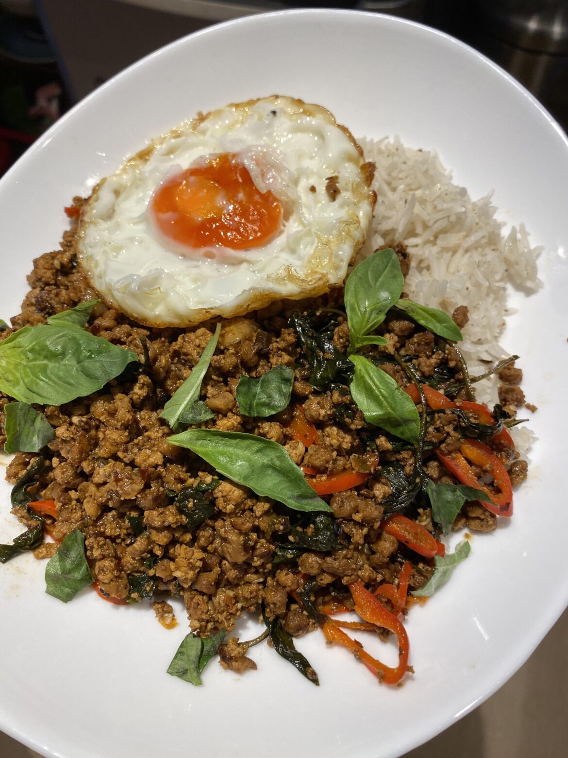 Vegetarian pad kra pao topped with an egg that’s been fried for too long :(