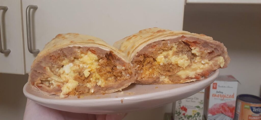 I made us spicy, cheesy bean, sausage and scrambled egg breakfast burritos 🤤 served with unpictured tortilla chips and coffee, lol