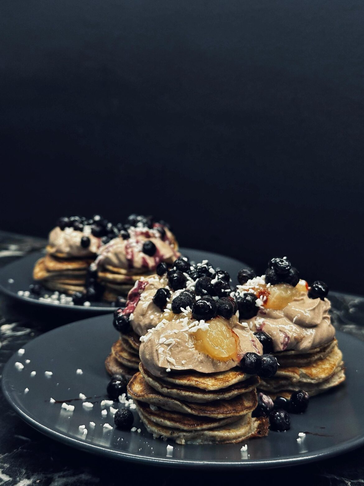 Banana pancakes, cacao powder mixed with yogurt, a little bit apple jam, blueberries and coconut flakes