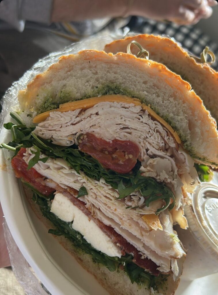 Turkey, sharp cheddar, candied bacon, arugula, fresh mozzarella, tomato, & pesto on Asiago bread