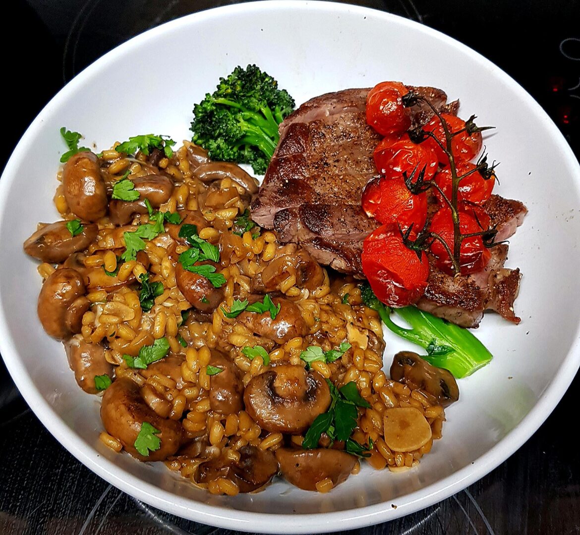 Quick Seared Flank Steak, Porcini and Chestnut Mushroom Risotto, Sautéed Brocolli and Blistered Vine Tomatoes.