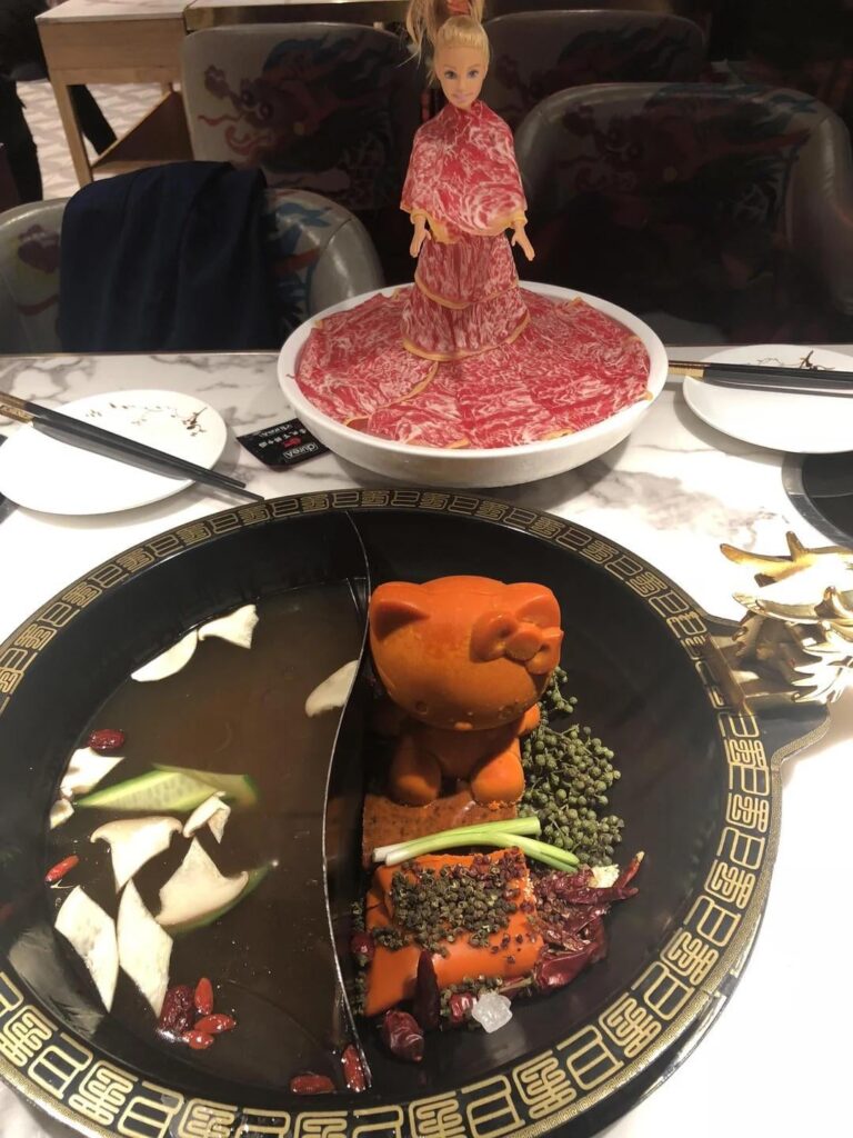 Hello Kitty hot pot with meat sliced and wrapped around a barbie doll