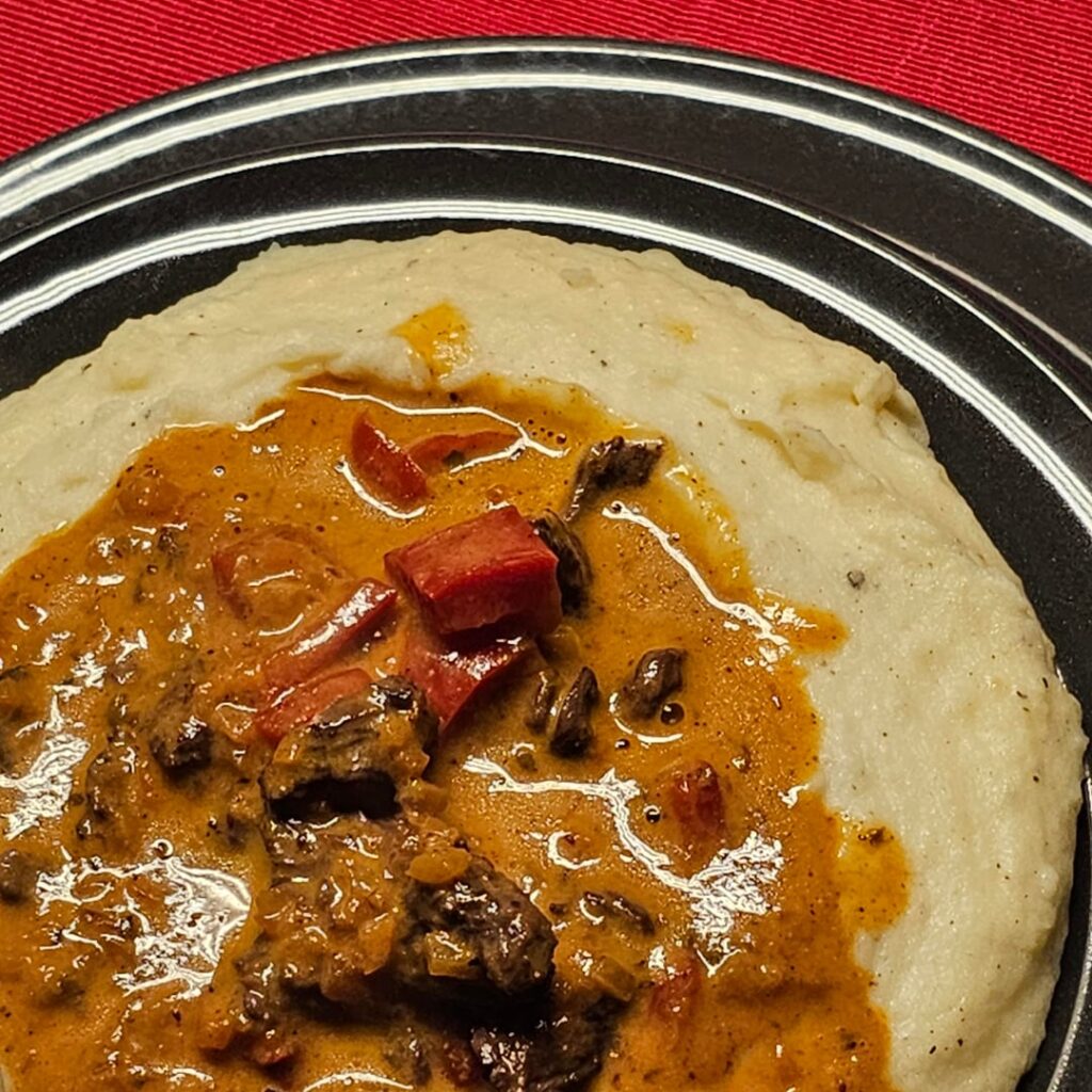 Mashed potatoes, with beef strips and bell peppers in a red wine/cranberry sauce, traditionally served in "Lake Mashed" ;)