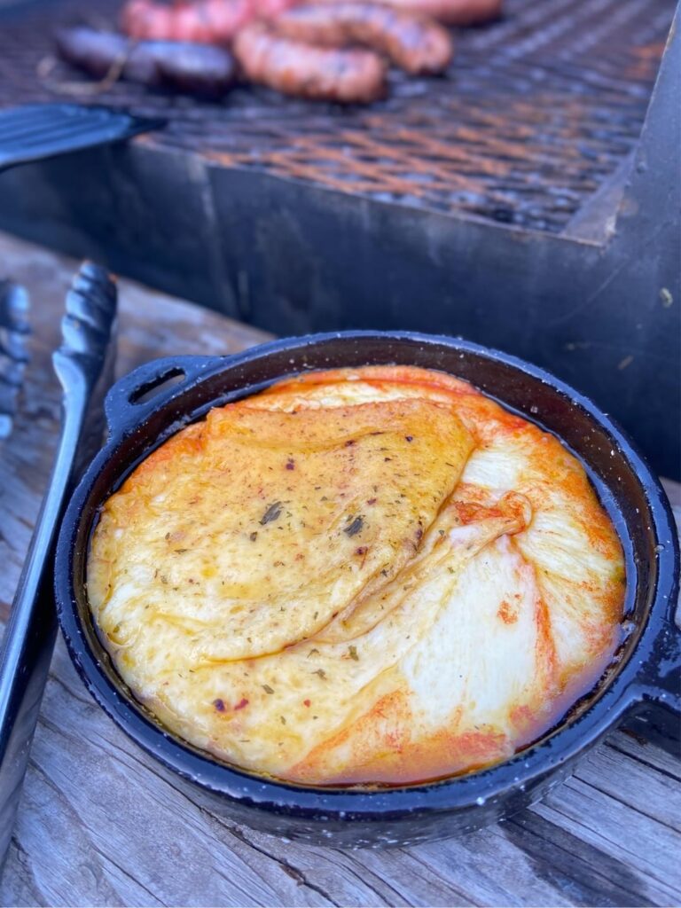 Grilled Provoleta. Provolone cheese. Served with chorizo, morcilla, bread, and a good red wine to pair with it.