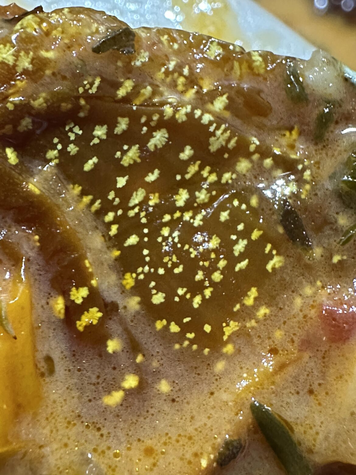 Hi all. Does anyone have a clue what these yellow spots are on this sun dried tomato? Straight from a brand new jar and none of the other ones look this way.